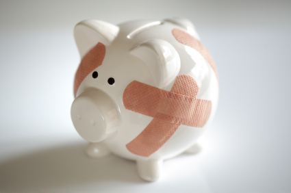 Piggy bank with band aids alternate text for this image