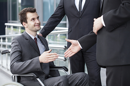 Disabled businessman shaking hand with business partners alternate text for this image