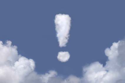 Exclamation point shaped cloud in a bright blue sky. alternate text for this image
