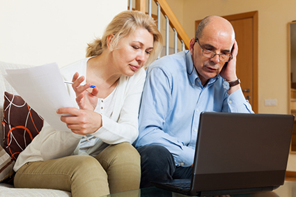 Serious mature man and woman with documents alternate text for this image