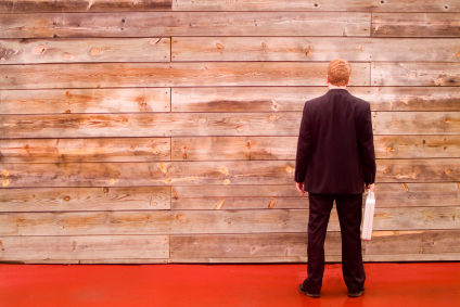 business man facing a wall alternate text for this image