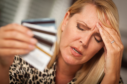 Very Upset Woman Holding Her Many Credit Cards. alternate text for this image
