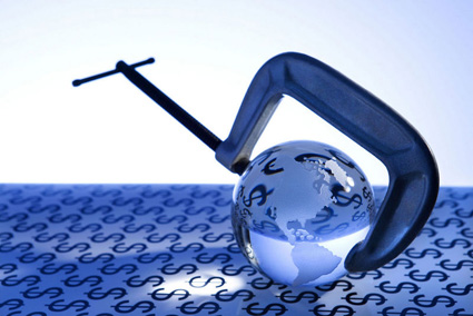 Glass globe being held by C clamp on blue background with money alternate text for this image