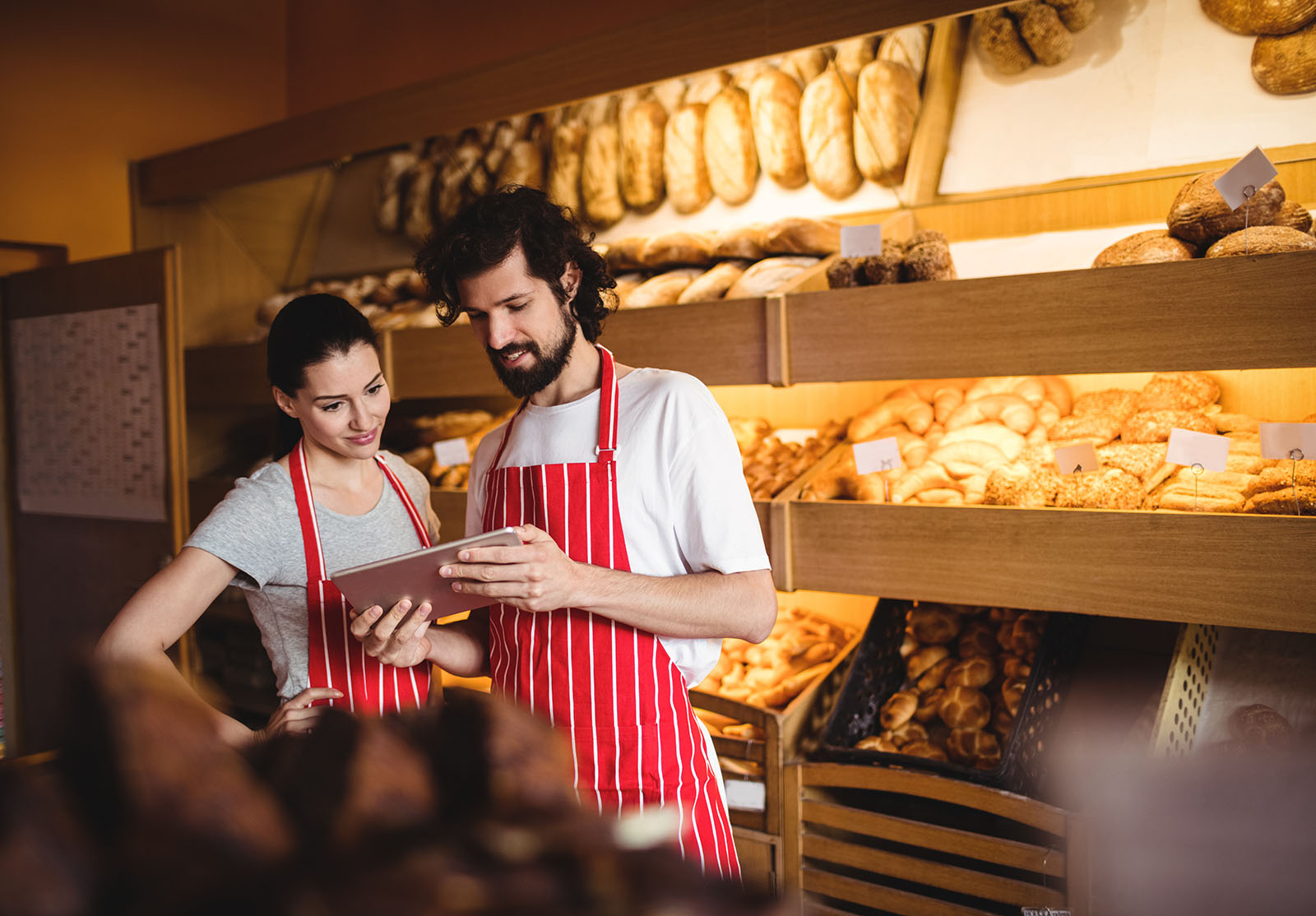 Couple using digital tablet alternate text for this image