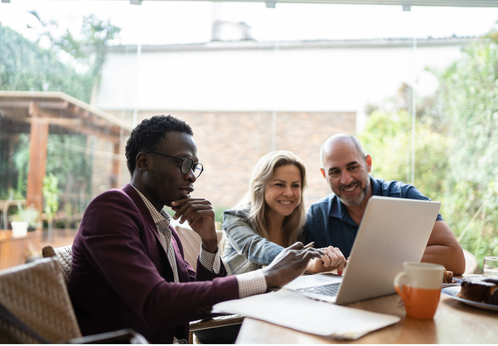 Financial advisor having a meeting with a couple at their home