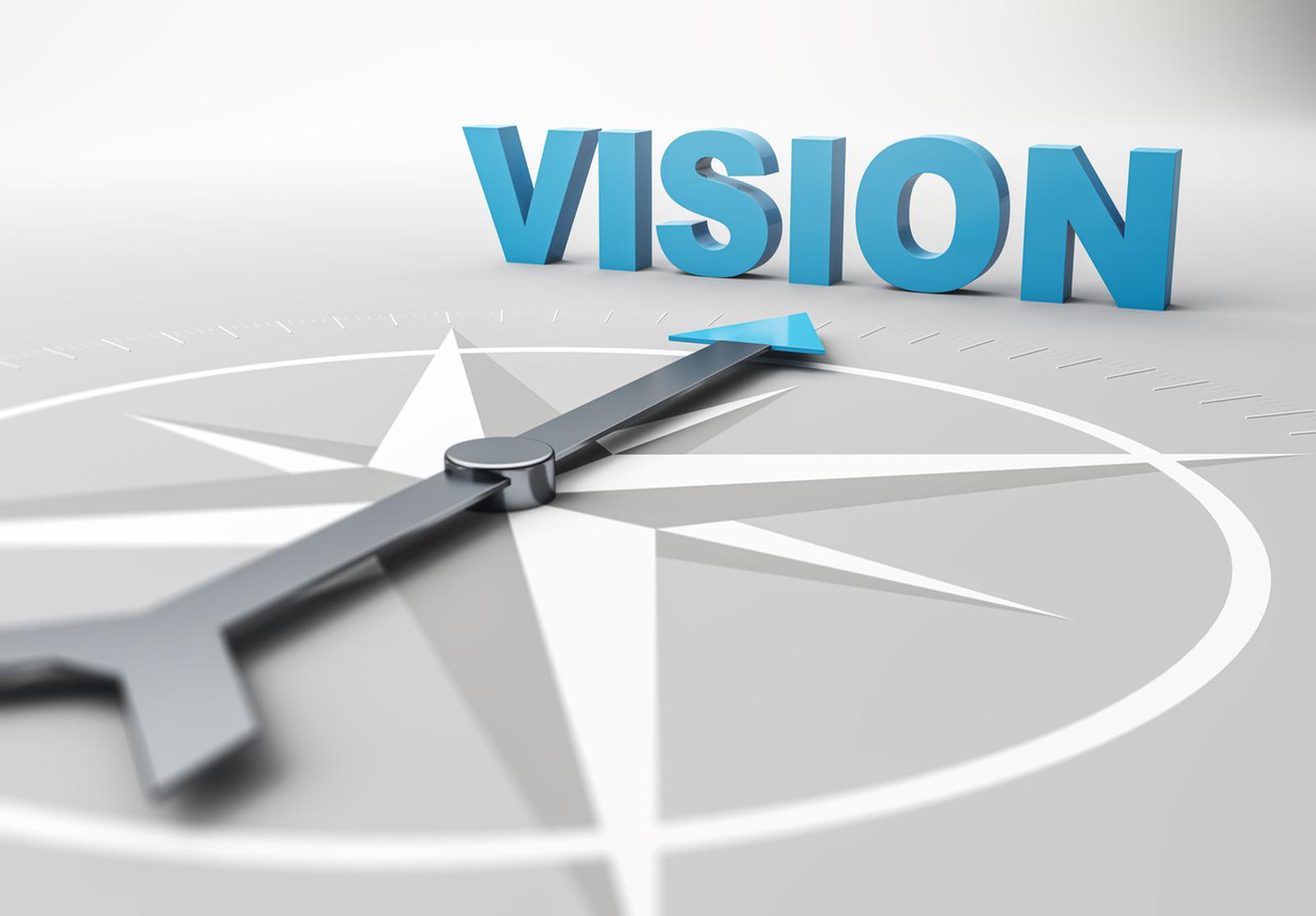 Une boussole grise avec une flèche bleue pointant vers le mot « VISION » en 3D. Illustration symbolique de l’orientation et de la vision d’avenir.
